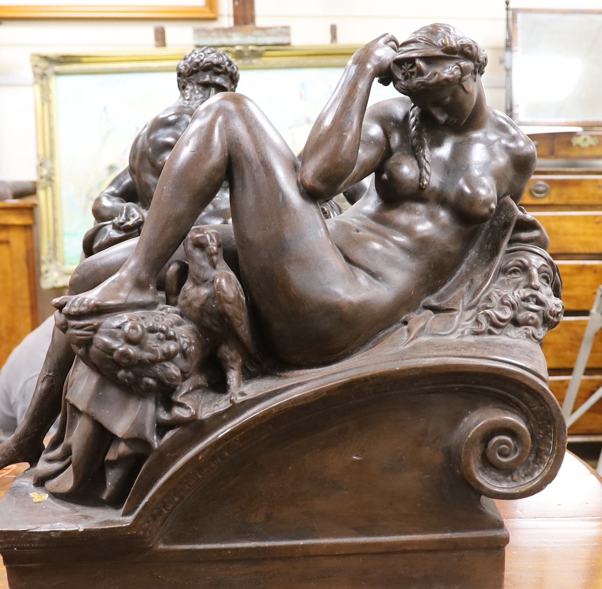 A pair of large classical composition reclining figures, 57 cm high